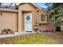 Inviting home entrance featuring a decorative wreath and well-manicured landscaping at 12610 E Wesley Pl, Aurora, CO 80014