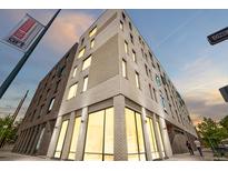 Modern multi-story apartment building featuring stylish brickwork and ample natural light from large windows at 603 Inca St # 530, Denver, CO 80204