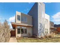 Modern two-story home with gray and neutral siding, large windows, and a well-kept front lawn at 3930 Yates St, Denver, CO 80212