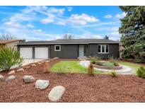 Charming single-story home featuring a two-car garage and a manicured front yard with beautiful landscaping at 129 Gordon Pl, Castle Rock, CO 80104