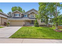 Inviting two-story home with a well-manicured lawn and attractive stone accents at 9743 Chanteclair Cir, Highlands Ranch, CO 80126