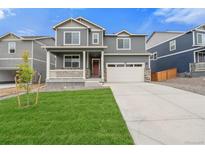 Two-story home with gray siding, red door and attached garage at 18134 Prince Hill Cir, Parker, CO 80134