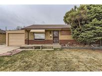 Charming brick home with a well-maintained front yard and a detached garage at 7251 Larsh Dr, Denver, CO 80221