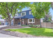Charming two-story home with a brick facade, blue siding, landscaped yard, and inviting entrance at 10621 Julian St, Westminster, CO 80031