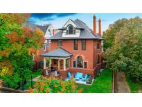 Beautiful brick home with a charming front porch and well-maintained landscaping at 2155 N High St, Denver, CO 80205