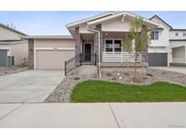 Charming single-Gathering home with stone accents, a well-maintained lawn, and a cozy front porch at 45946 Gentry Ave, Bennett, CO 80102