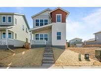 Charming two-story home featuring varied siding, inviting front porch, and meticulous landscaping at 5928 N Lisbon St, Aurora, CO 80019