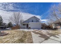 Charming two-story home with well-maintained lawn, inviting curb appeal, and attached two-car garage at 12521 S Elk Creek Way, Parker, CO 80134