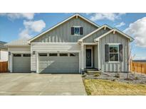Charming exterior showcasing a two-car garage, well-maintained lawn, and inviting entryway for a welcoming curb appeal at 1171 Nathan Pl, Erie, CO 80026