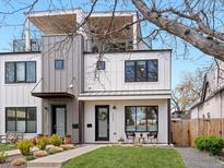 Stylish modern two-story home with clean lines, white and gray siding, and a welcoming front yard at 4525 N Raleigh St, Denver, CO 80212