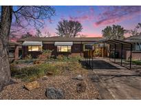 Charming brick home showcasing a well-maintained front yard and covered carport at 2064 Ironton St, Aurora, CO 80010