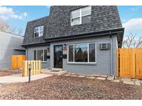 Gray duplex exterior with new wood fence and landscaping at 1442 S Logan St, Denver, CO 80210