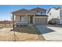 Charming two-story home with a front porch and a two-car garage at 5918 Red Barn Ave, Mead, CO 80504