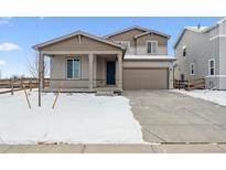 Inviting two-story home showcasing a manicured lawn, covered entrance, and an attached two-car garage at 5918 Red Barn Ave, Mead, CO 80504