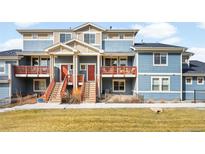 Charming townhomes with private balconies and manicured front lawns create a welcoming curb appeal at 883 Widgeon Cir, Longmont, CO 80503