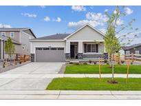 Charming single-story home with well-manicured lawn, gray siding, and a covered front porch at 24740 E 39Th Ave, Aurora, CO 80019