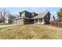 A lovely, two-story home with an attached garage and a well-manicured lawn at 5149 S Genoa Ct, Centennial, CO 80015