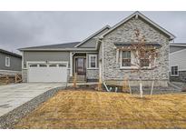 Charming single-Gathering home featuring stone accents, a two-car garage, and a well-manicured front yard at 3630 Gold Bug St, Aurora, CO 80019