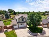 Beautiful two-story home boasts a three car garage, and well-manicured lawn at 9916 Sand Cherry Way, Highlands Ranch, CO 80129