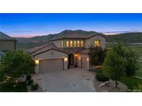 Stunning home with a three-car garage and picturesque mountain views in the background at 15490 W Asbury Ave, Lakewood, CO 80228