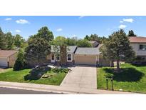Charming single-Gathering home with a well-manicured lawn and an attached garage, nestled among mature trees at 10832 W Powers Pl, Littleton, CO 80127