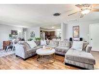 Spacious living room featuring a large sectional sofa and hardwood floors at 1800 S Tennyson St, Denver, CO 80219