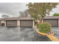 Attached garages with brown doors offer convenient parking and storage in this townhome community at 12010 E Harvard Ave, Aurora, CO 80014