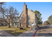 Charming townhouse featuring a brick chimney and well-maintained landscaping at 1731 S Blackhawk Way # A, Aurora, CO 80012