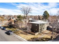 Aerial view of a complex of buildings with landscaping and parking at 936 Eudora St # 102, Denver, CO 80220