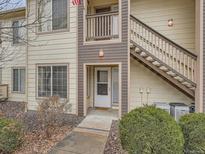 Charming condo entrance with stairs, featuring neutral siding and well-maintained landscaping at 5455 S Dover St # 101, Littleton, CO 80123