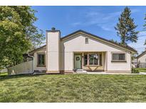 Charming single-story home with cream siding, a chimney, and a well-maintained lawn at 7830 W 90Th Ave # 67, Broomfield, CO 80021