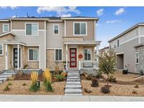 Charming two-story home with a red front door, landscaped yard, and inviting entryway at 1635 S Andes Way, Aurora, CO 80017