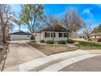 Charming single-story home featuring a well-maintained yard and detached two-car garage at 6133 S Sterne Cir, Littleton, CO 80120