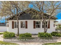 Charming home with lush greenery and mature trees, showcasing its inviting curb appeal and well-maintained exterior at 6133 S Sterne Cir, Littleton, CO 80120