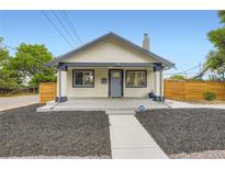 Charming bungalow-style home with a fresh exterior, tidy landscaping, and inviting front porch at 1694 Xanthia St, Denver, CO 80220