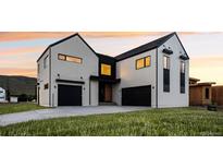 Modern two-story home with sleek exterior and dark garage doors at 5031 Moss Pl, Golden, CO 80403