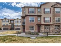 Charming multi-story home with stone accents, landscaped yard, and a welcoming entrance at 2225 Santini Trl # A, Littleton, CO 80129