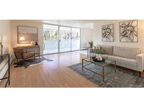 Bright living room featuring a sliding glass door to a balcony and modern decor at 1090 N Lafayette St # 305, Denver, CO 80218