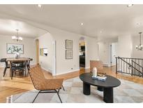 Open-concept living room features hardwood floors, neutral paint, and contemporary furnishings at 3355 Wright St, Wheat Ridge, CO 80033