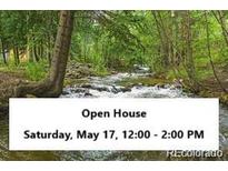 Scenic view of creek through property with Open House banner at 2971 Fall River Rd, Idaho Springs, CO 80452