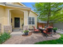 Inviting front patio with comfortable seating and a cozy fire pit, perfect for outdoor relaxation at 7638 S Hudson Way, Centennial, CO 80122