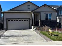 Charming single Gathering home featuring neutral siding, large garage, and manicured lawn at 22822 E Union Cir, Aurora, CO 80015