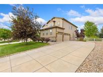 Beautiful two-story home with a large driveway and an attached two-car garage at 2647 Gray Wolf Loop, Broomfield, CO 80023
