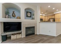 Inviting living room featuring a fireplace and built-in shelving, perfect for relaxing and entertaining at 11277 Osage Cir # E, Northglenn, CO 80234