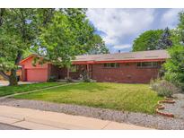 Charming brick home featuring a well-maintained lawn and a lovely covered porch at 4465 Cody St, Wheat Ridge, CO 80033