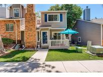 Charming exterior of a two-story home with a brick chimney and cozy front porch at 709 S Depew St, Lakewood, CO 80226