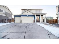 Inviting two-story home boasts a large driveway and attached two-car garage at 10669 Worchester Dr, Commerce City, CO 80022