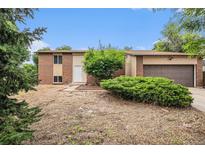 Charming two-story home featuring a brick facade, well-maintained landscaping, and a two-car garage at 3246 S Nucla St, Aurora, CO 80013