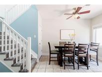 Bright dining room with a ceiling fan and staircase leading to the next level at 2800 Aurora Ave # 121, Boulder, CO 80303