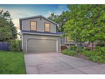 Charming two-story home with a well-maintained lawn and a large two car garage at 284 S Lincoln Ave, Louisville, CO 80027